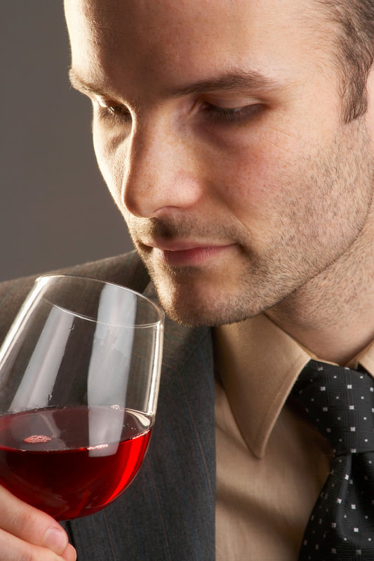 Guy smelling wine